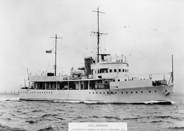 HMS Grasshopper sailing on calm waters.